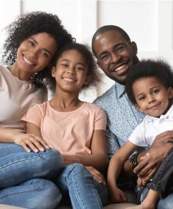 Smiling Family Sitting on Sofa